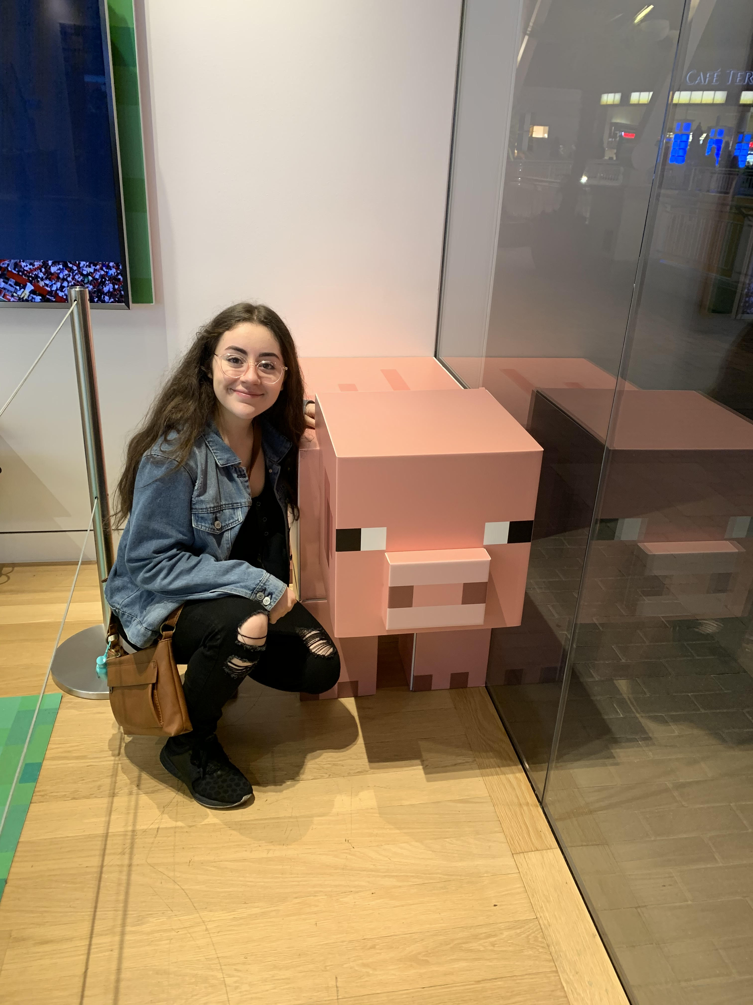 Sandra Crouching by a Mincraft Pig 